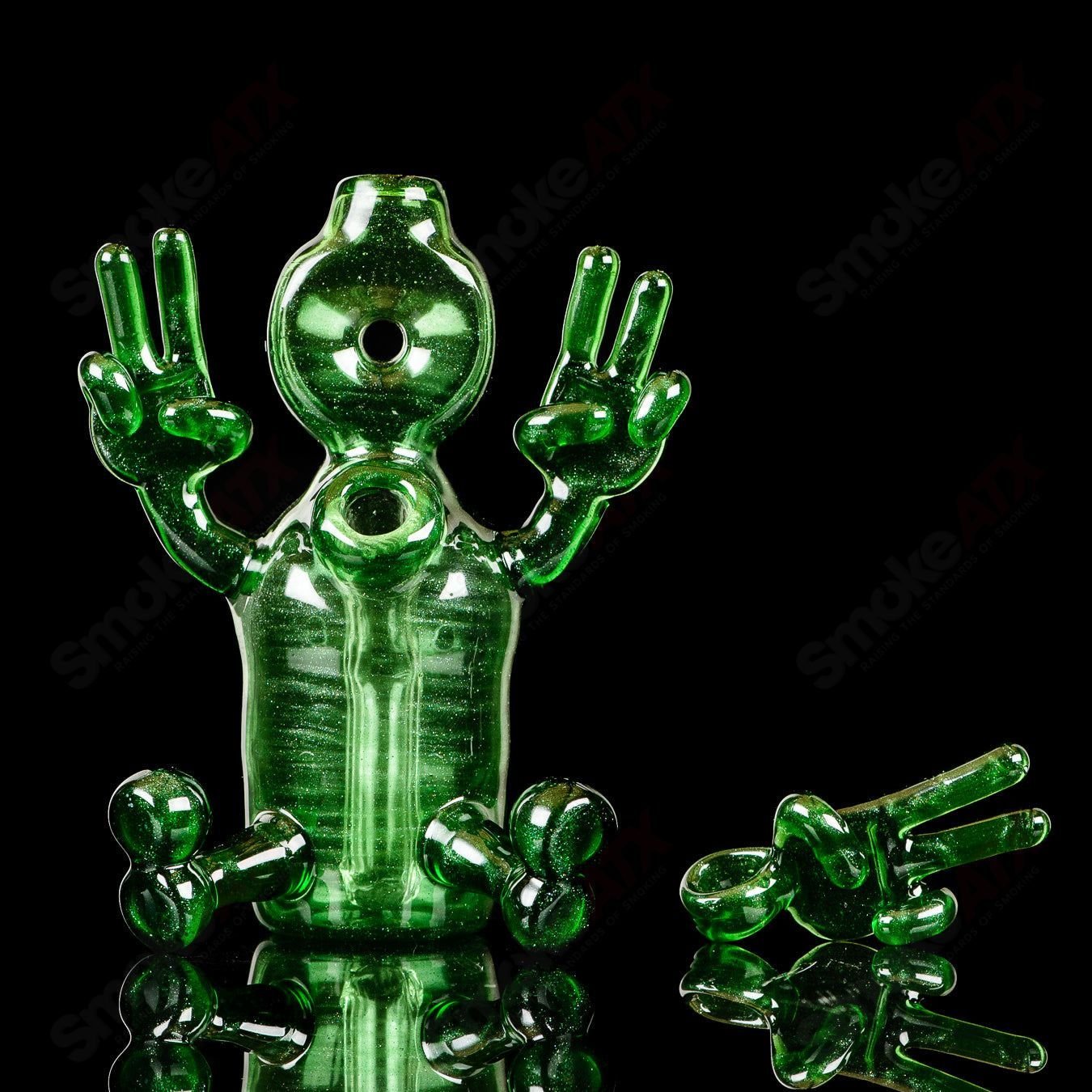 Green Sitter Tube concentrate rig with pendant from MJ Meltz, heady glass with intricate design and vibrant green color.