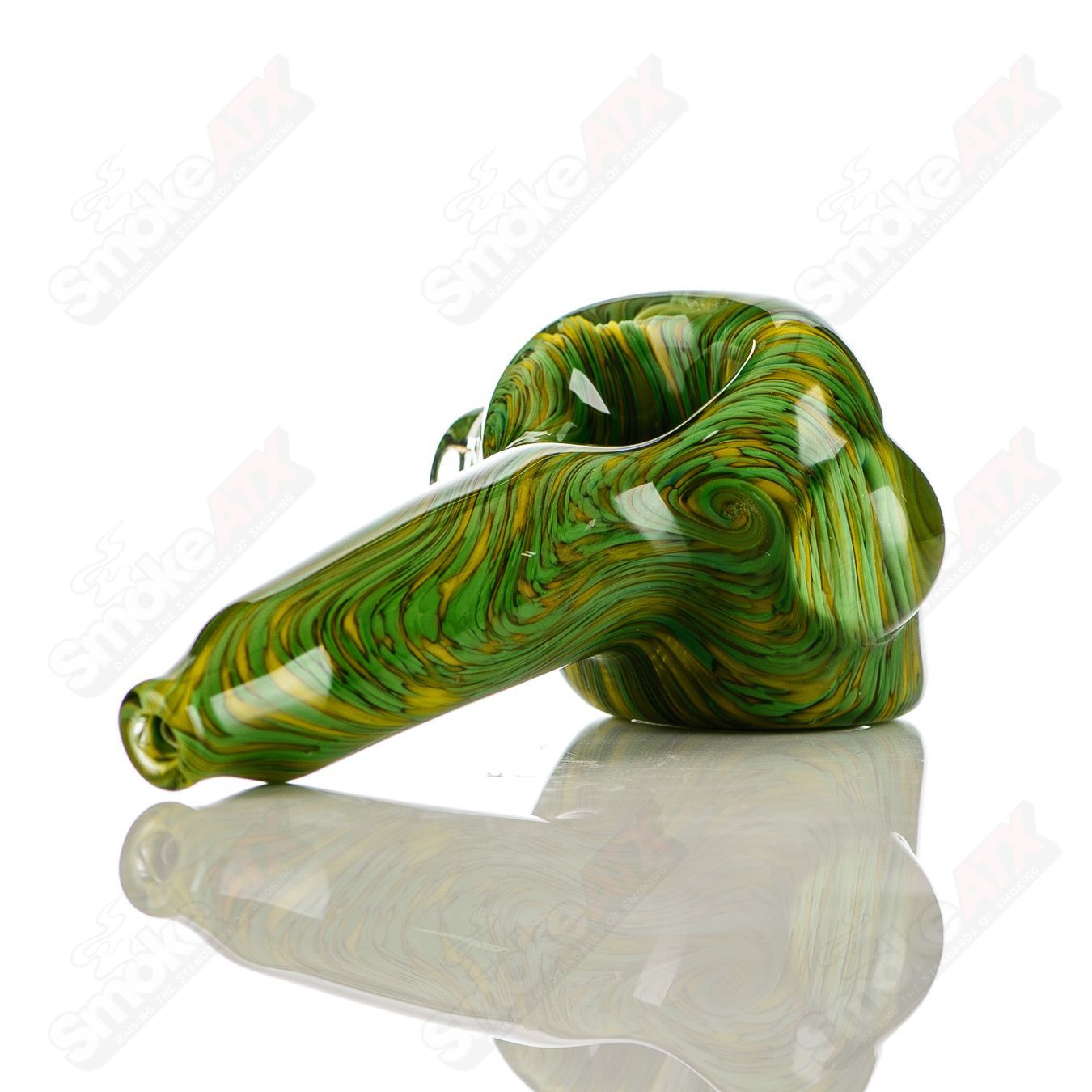 Green and yellow worked glass spoon pipe signed by JMK Glass, featuring intricate patterns and craftsmanship in a hand pipe design.