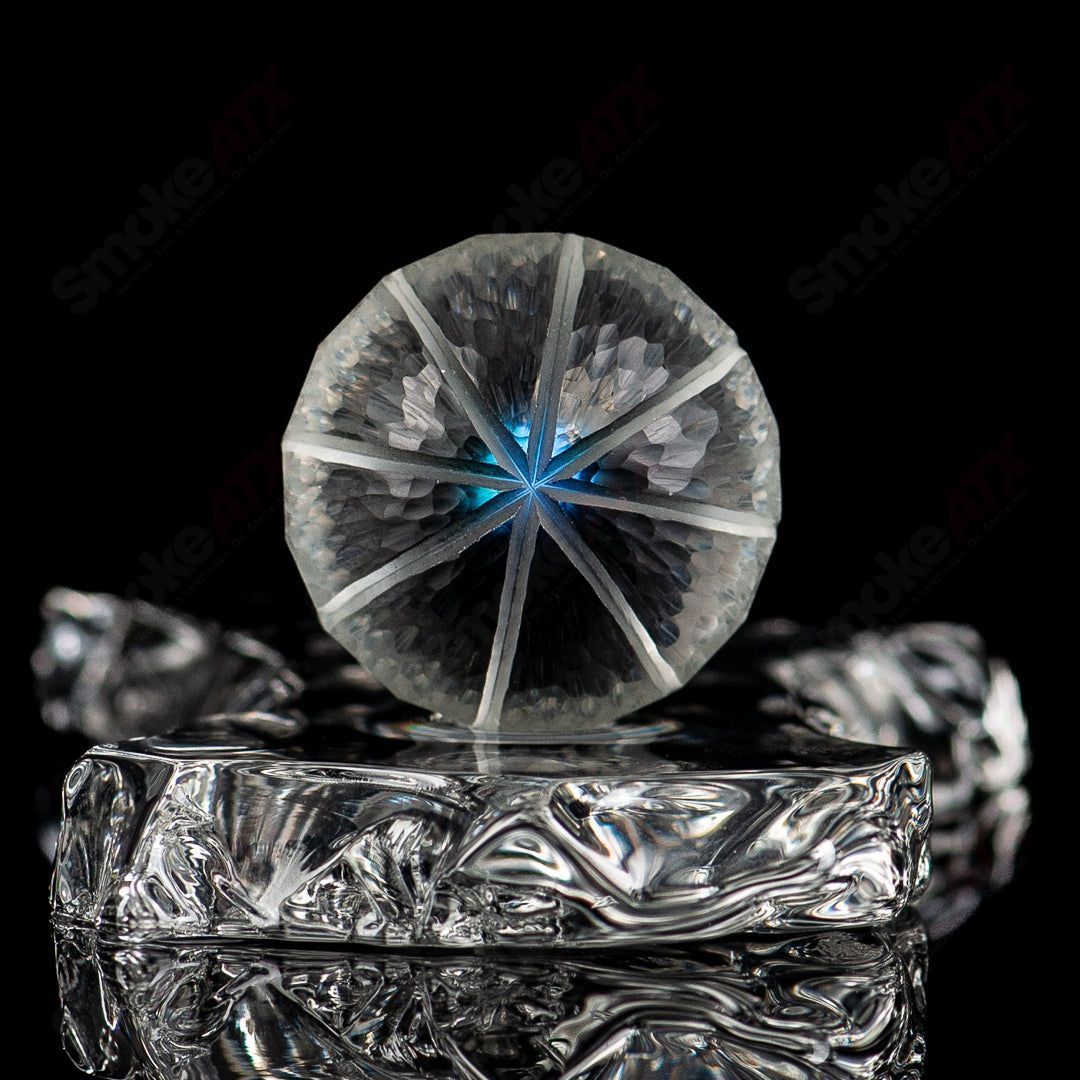 Opal faceted marble by Fatal Facets, a heady glass marble with shimmering opal and carved facets, displayed on a plain background.