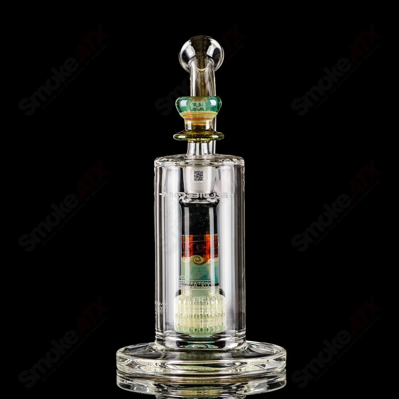 Mobius Ion Matrix V1 Accent Series glass bubbler with intricate design and clear glass body, showcasing artistic craftsmanship.