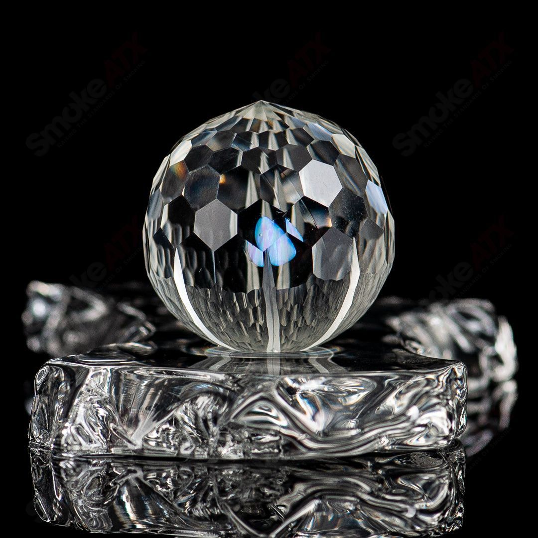 Opal faceted glass marble from Fatal Facets with a smooth, polished surface and colorful marble design.