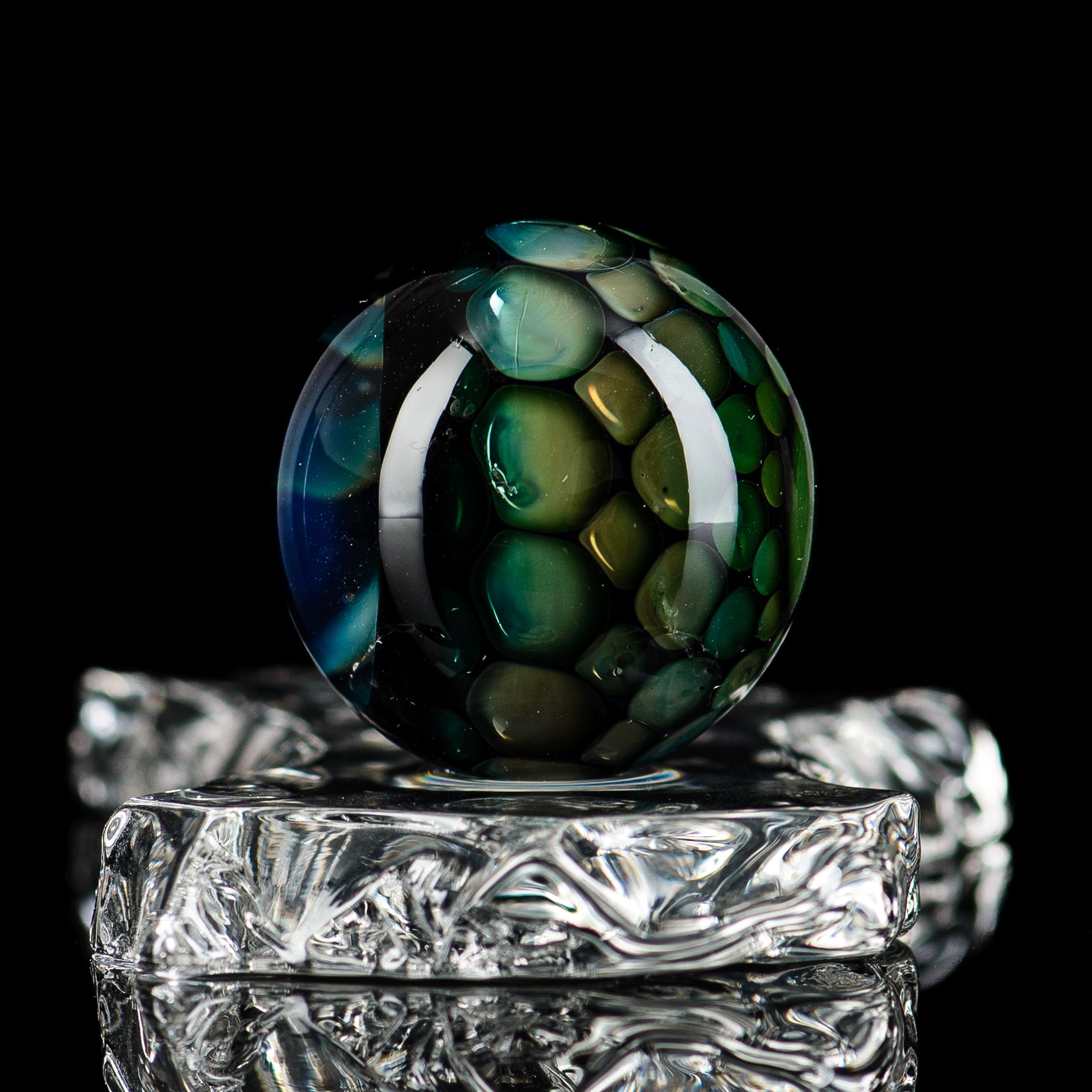 Colorful #2 marble from Flex Glass marble collection, showcasing smooth, glossy glass marbles with a marble pattern.