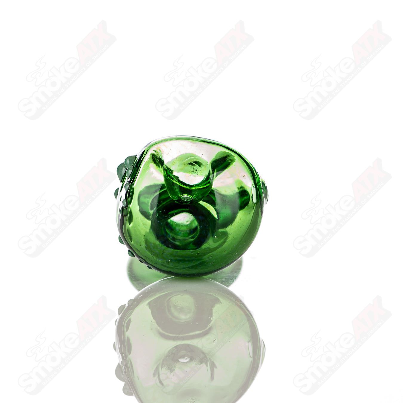 Large green Layback spoon hand pipe by JMass, made of heady glass with a smooth, curved design for easy handling and use.