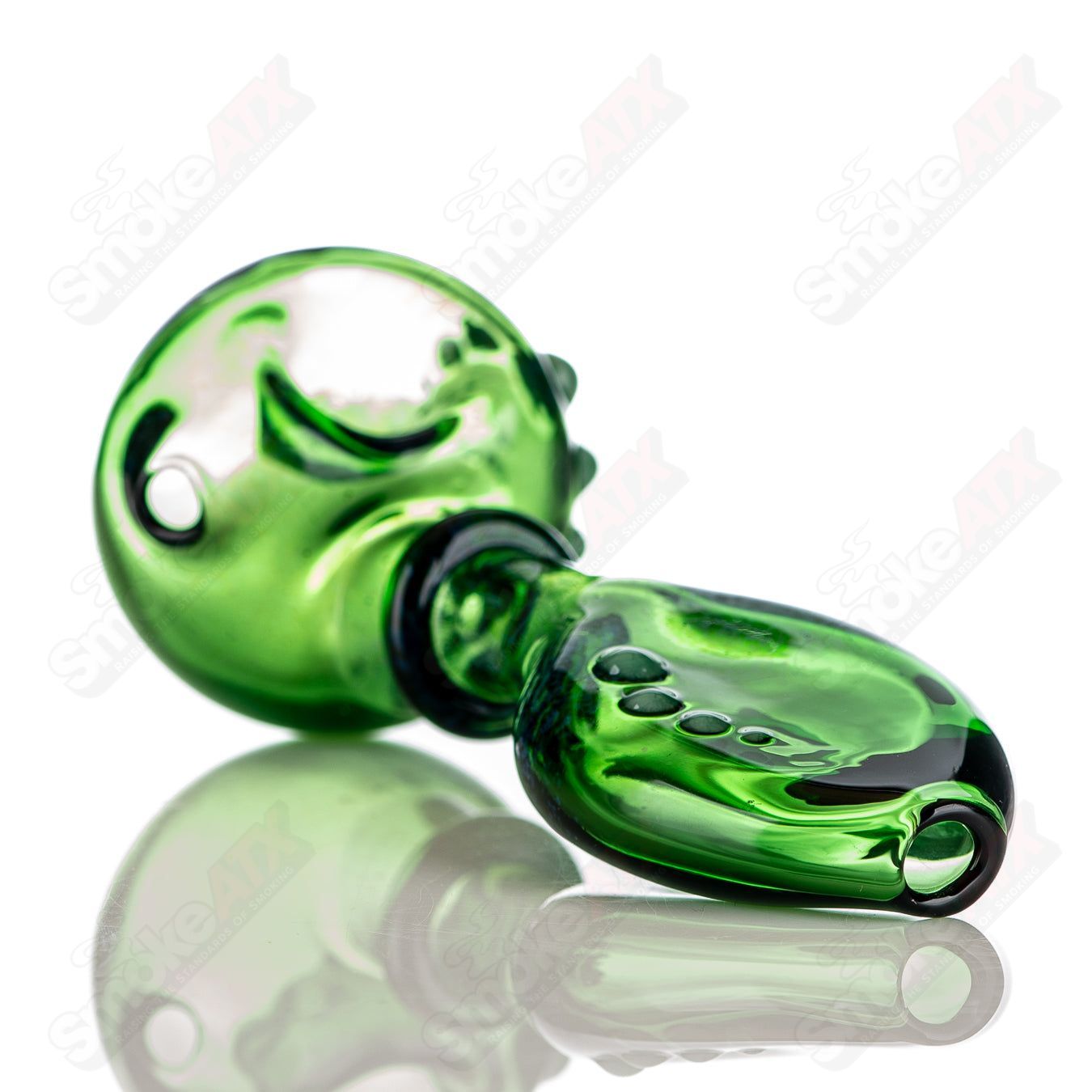 Large green Layback spoon hand pipe by JMass, made of heady glass with a vibrant green finish and ergonomic design.