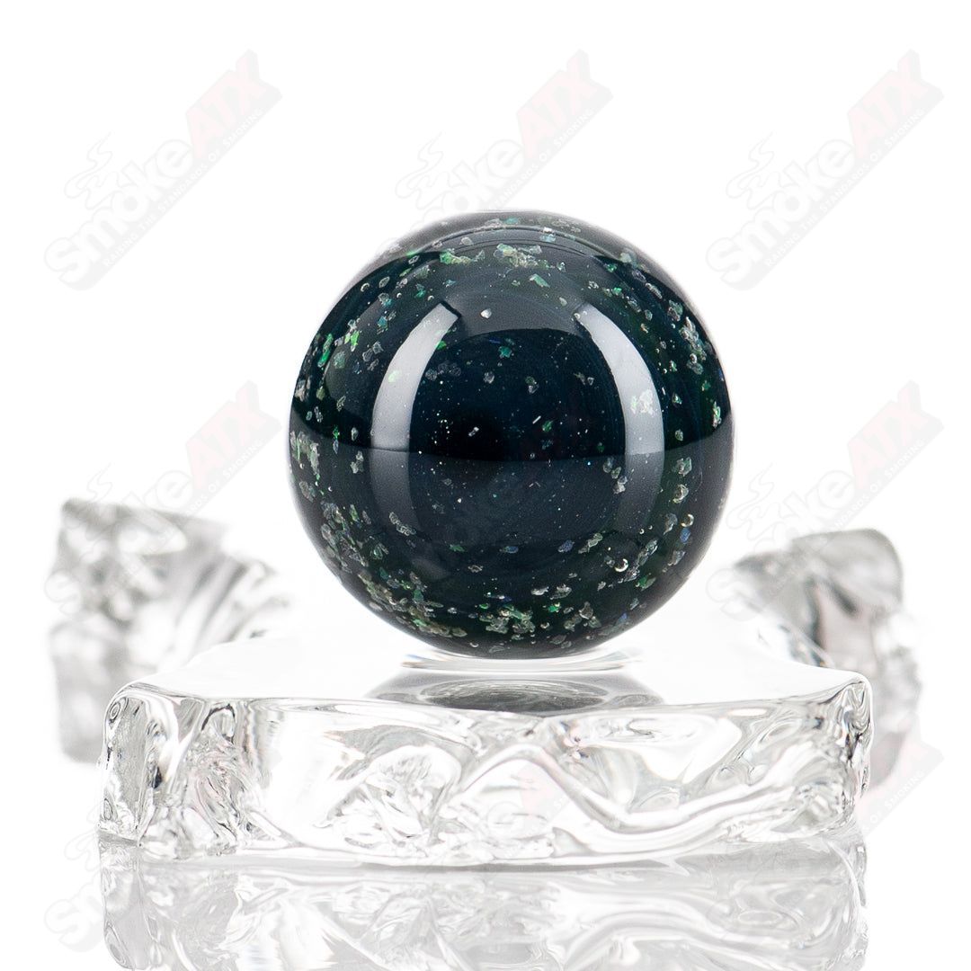 Black Magic UV Pinwheel Top marble by Indo Glass, colorful glass marble with vibrant pinwheel pattern and UV-reactive design.