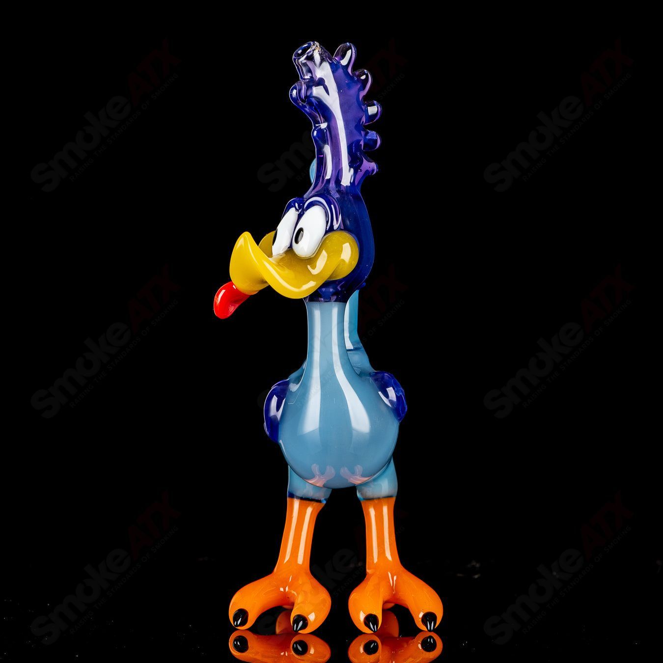 Looney Tunes Roadrunner concentrate rig by J-Smart Glass, featuring colorful cartoon design and clear glass construction.