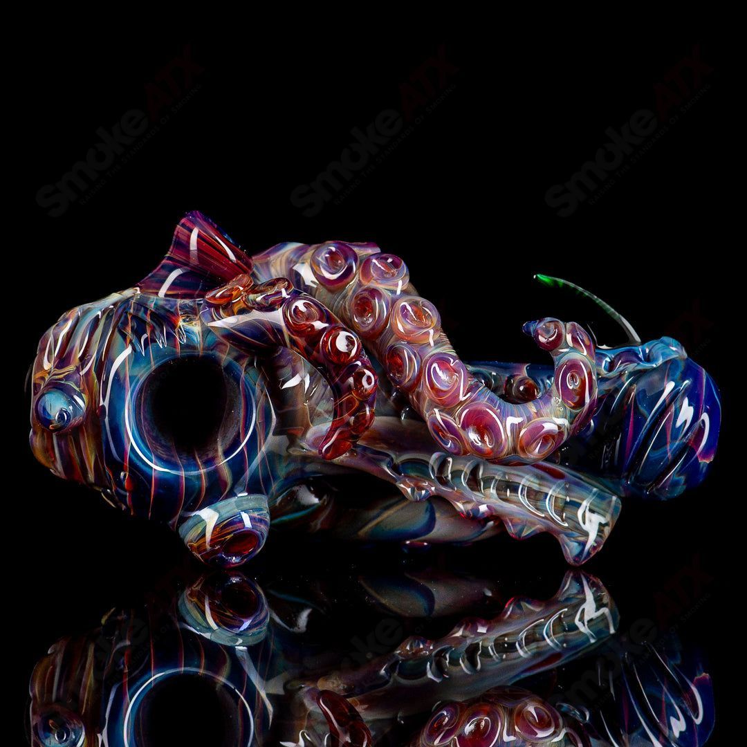 Colorful Seamonster hand pipe by Mako Glass, vibrant heady glass pipe featuring a detailed sea creature design.