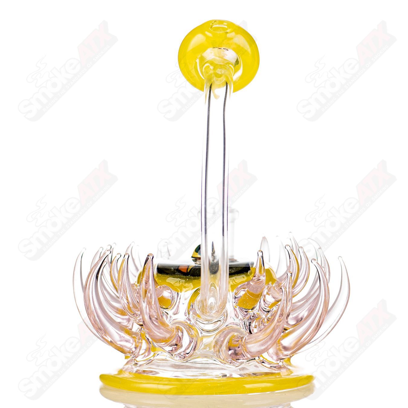 Pink and yellow mini rig by Freeek Glass, colorful heady glass concentrate rig with a compact design and intricate details.