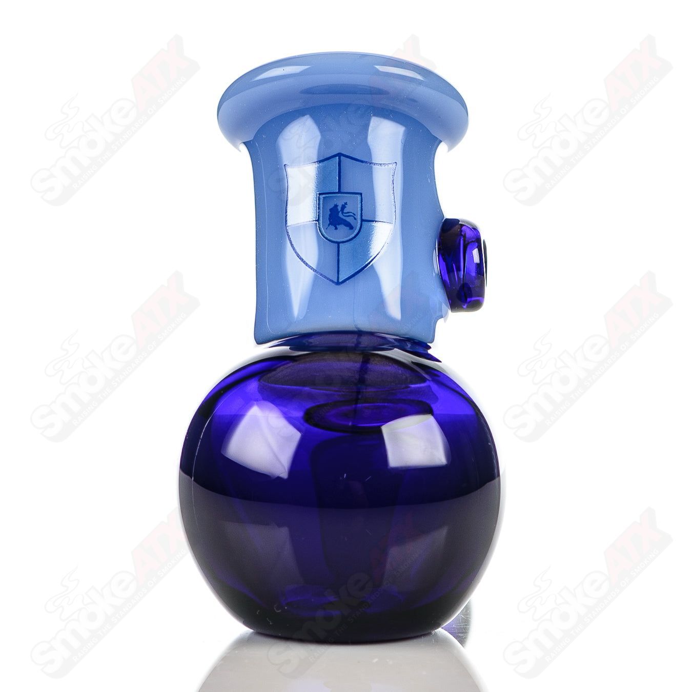 Illadelph glass multi-hole hammer hand pipe in cobalt and milky blue with multiple holes and a smooth, rounded design.