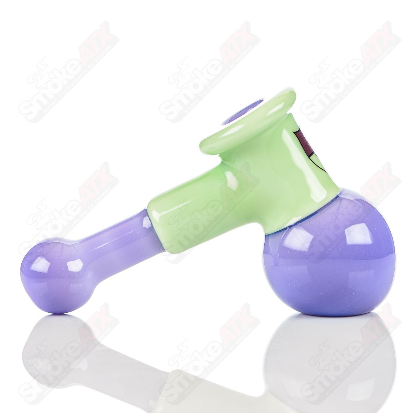 Illadelph glass multi-hole hammer hand pipe in milky green and pink with multiple holes, designed for smooth smoking experience.