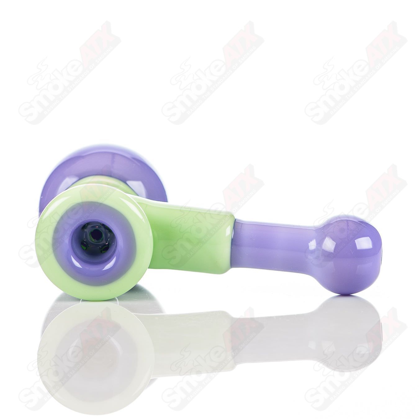 Illadelph glass multi-hole hammer hand pipe in milky green and pink with multiple holes for enhanced airflow.