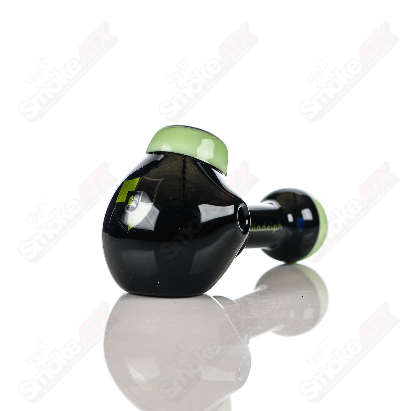 Illadelph glass multi-hole spoon pipe in black and milky green with multiple holes, designed for smooth smoking experience.