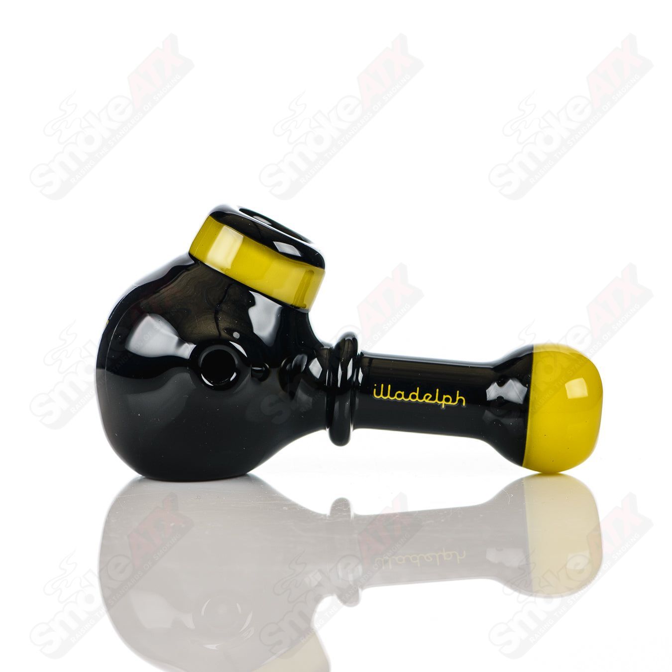 Illadelph black and yellow glass multi-hole spoon pipe with multiple holes and a smooth, rounded bowl design.