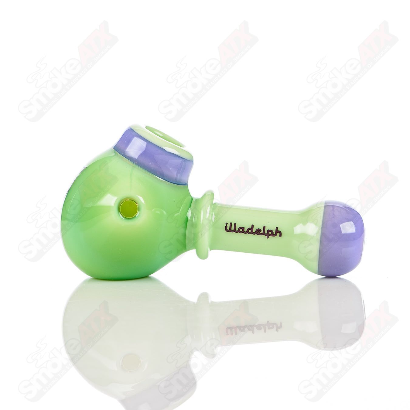 Illadelph glass multi-hole spoon pipe in milky green and purple, featuring multiple holes and a smooth, rounded design.