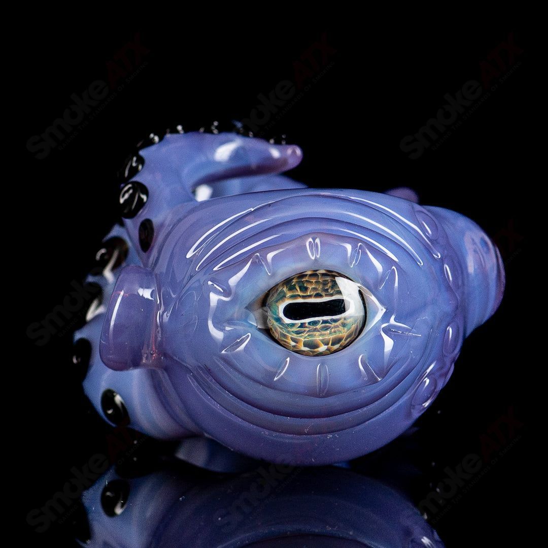 Clear Seamonster spoon hand pipe by Mako Glass, featuring a detailed sea creature design in vibrant glass.