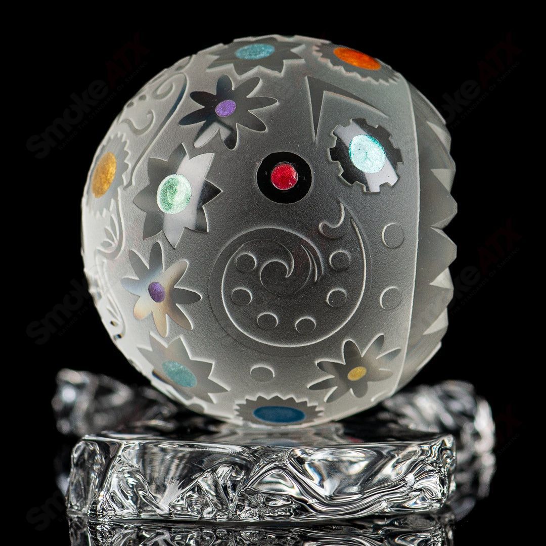 Faceted Skull Marble by Fatal Facets, handcrafted glass head-shaped marble with intricate faceted design, on a neutral background.