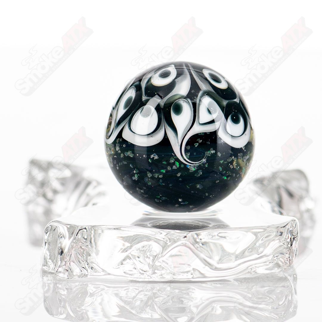 Black Magic UV Pinwheel Top marble by Indo Glass, colorful glass marble with vibrant pinwheel design and UV-reactive features