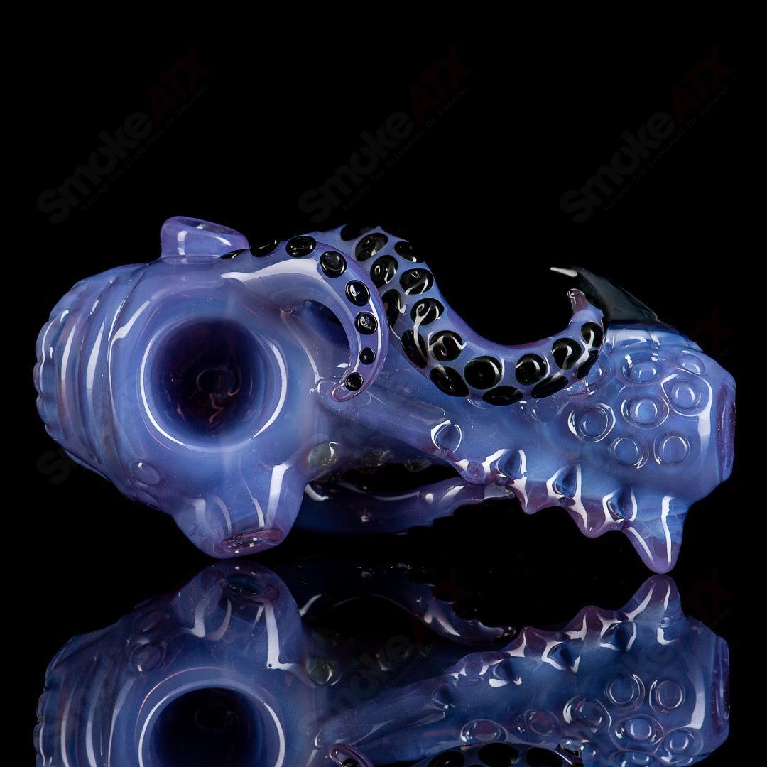 Mako Glass Seamonster Spoon hand pipe with blue and green glass design, featuring a detailed sea creature motif.