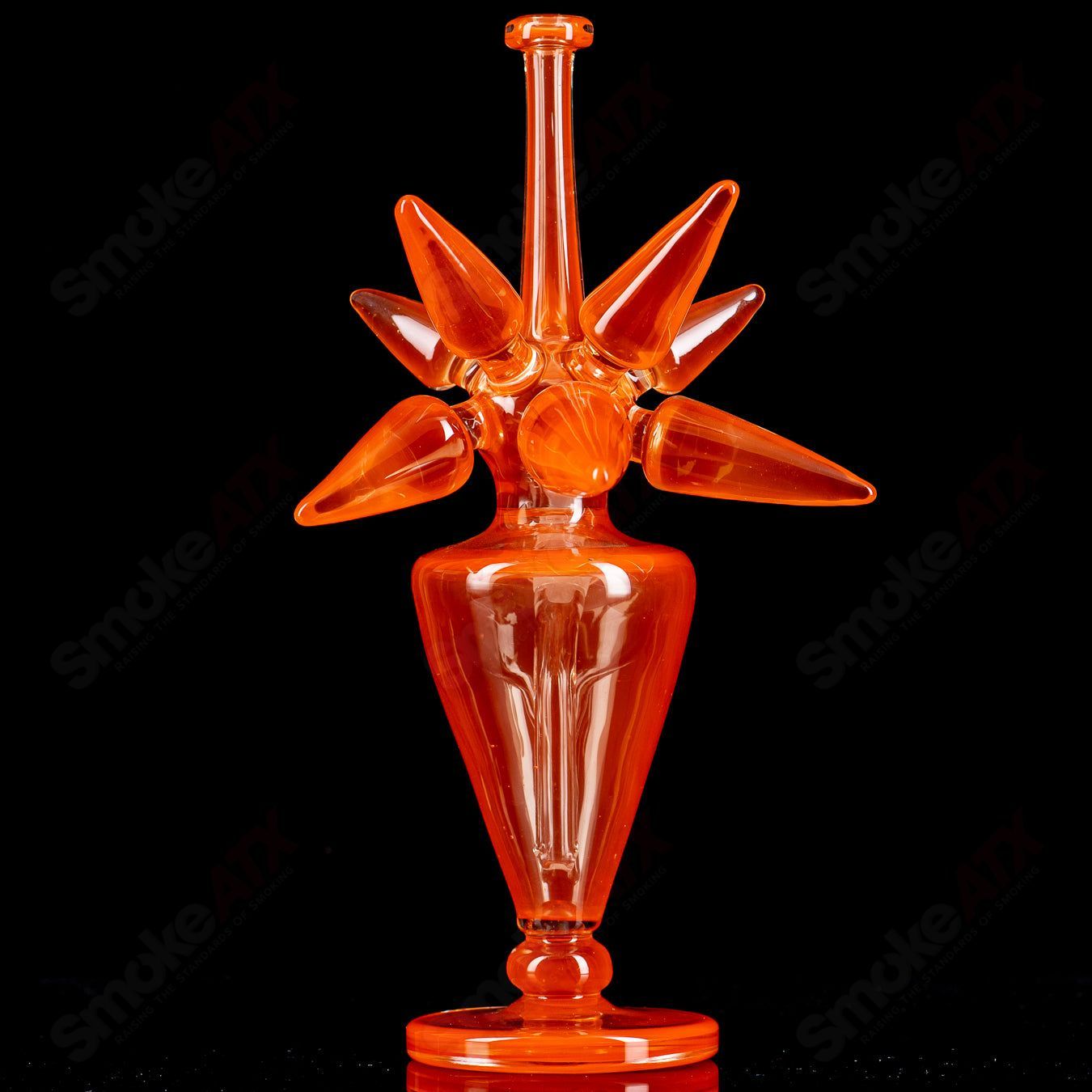 JMass OJ Spike Bottle Rig, heady glass concentrate rig with a unique spike design, clear glass with colorful accents.