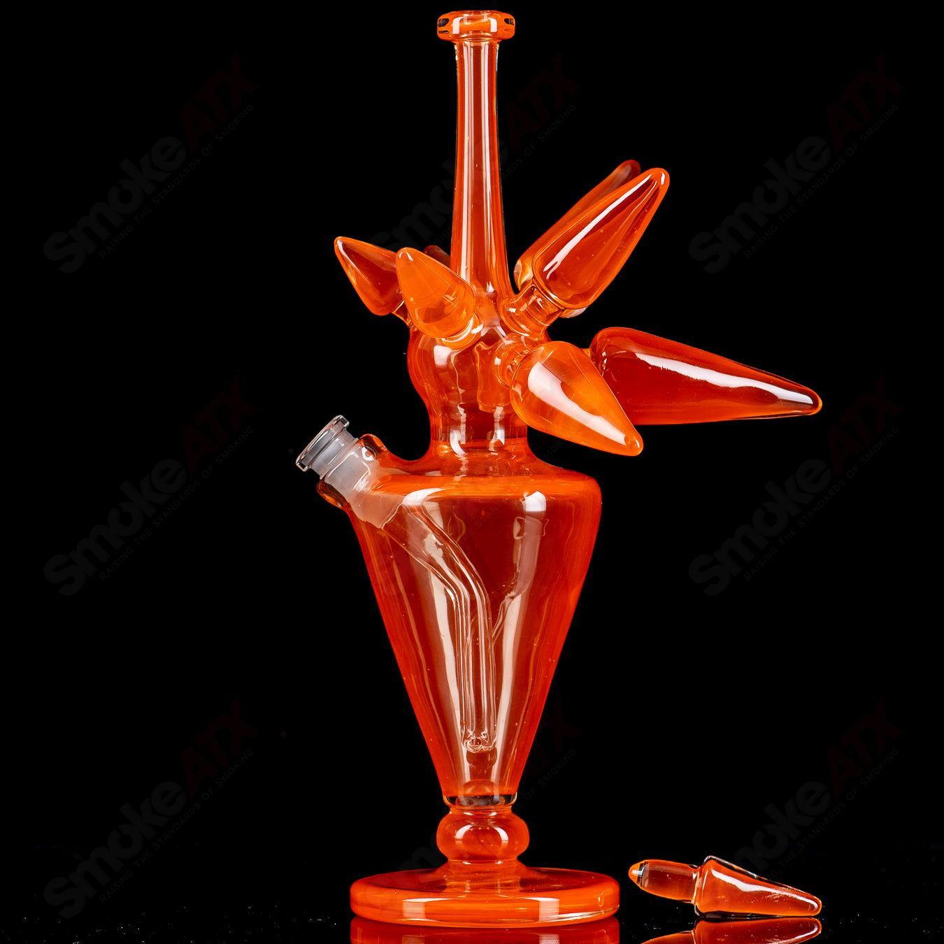 JMass OJ Spike Bottle Rig, a heady glass concentrate rig with a vibrant orange spike design and sturdy glass construction.