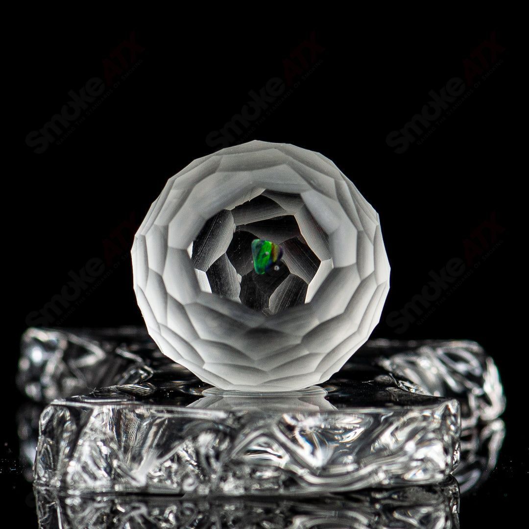 Faceted marble by Fatal Facets, a colorful glass heady marble with intricate faceted design and vibrant patterns.