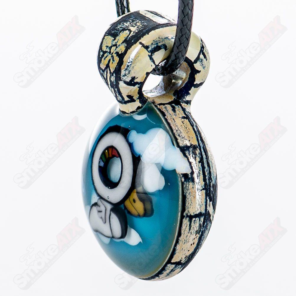 Calmbo x Trevy Metal Heady Glass Pendant featuring intricate design and vibrant colors, hanging from a chain.