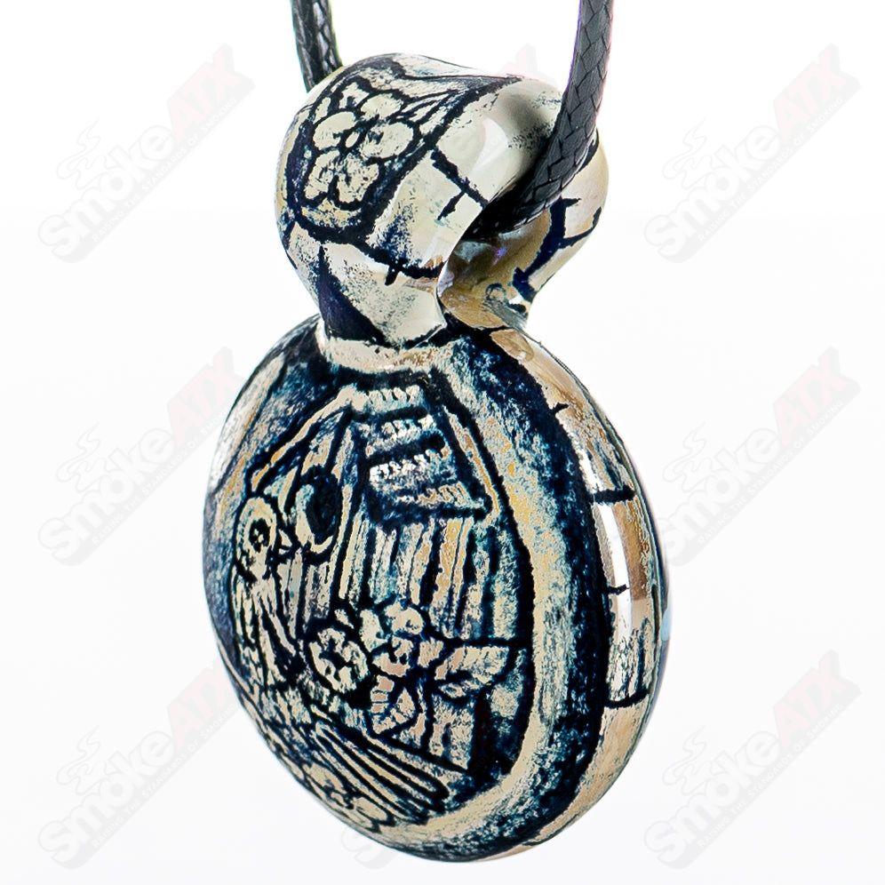 Heady glass pendant by Calmbo x Trevy Metal, featuring intricate design and vibrant colors on a clear glass pendant.