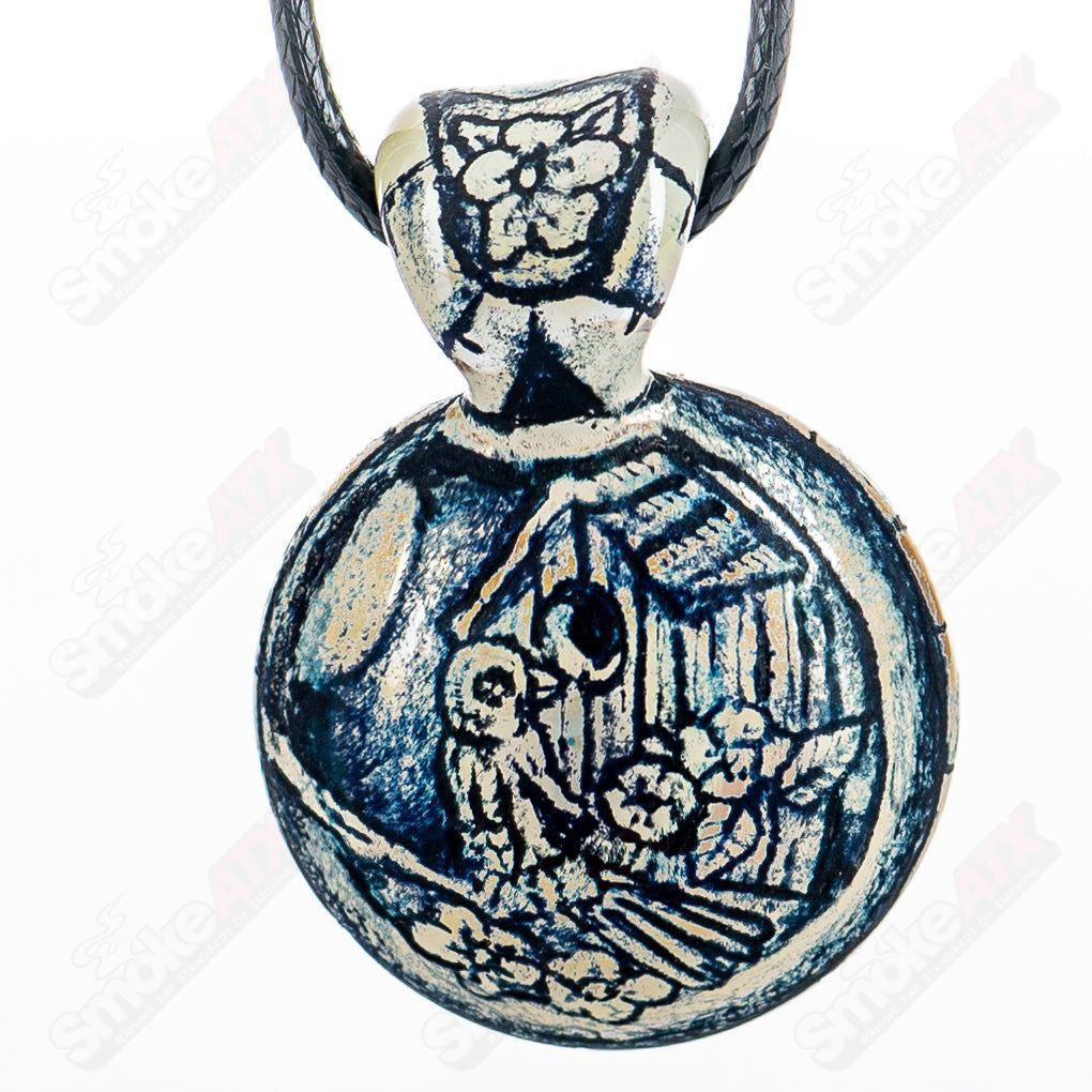 Calmbo x Trevy Metal Heady Glass pendant featuring a colorful, intricate design, hanging from a metal chain.