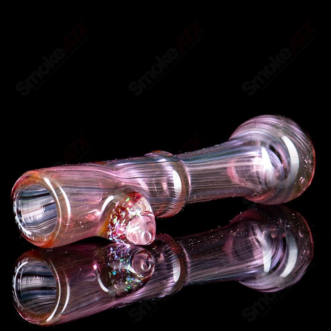 Pink heady glass chillum with crushed opal accents by JMass, showcasing a smooth, colorful design and transparent glass finish.