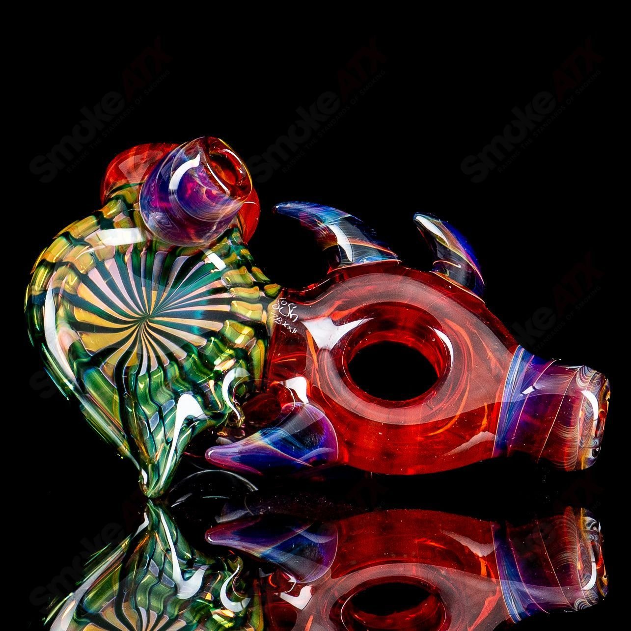 Dosh Glass Piranha Hand Pipe, heady glass hand pipe with a detailed piranha design and vibrant colors.