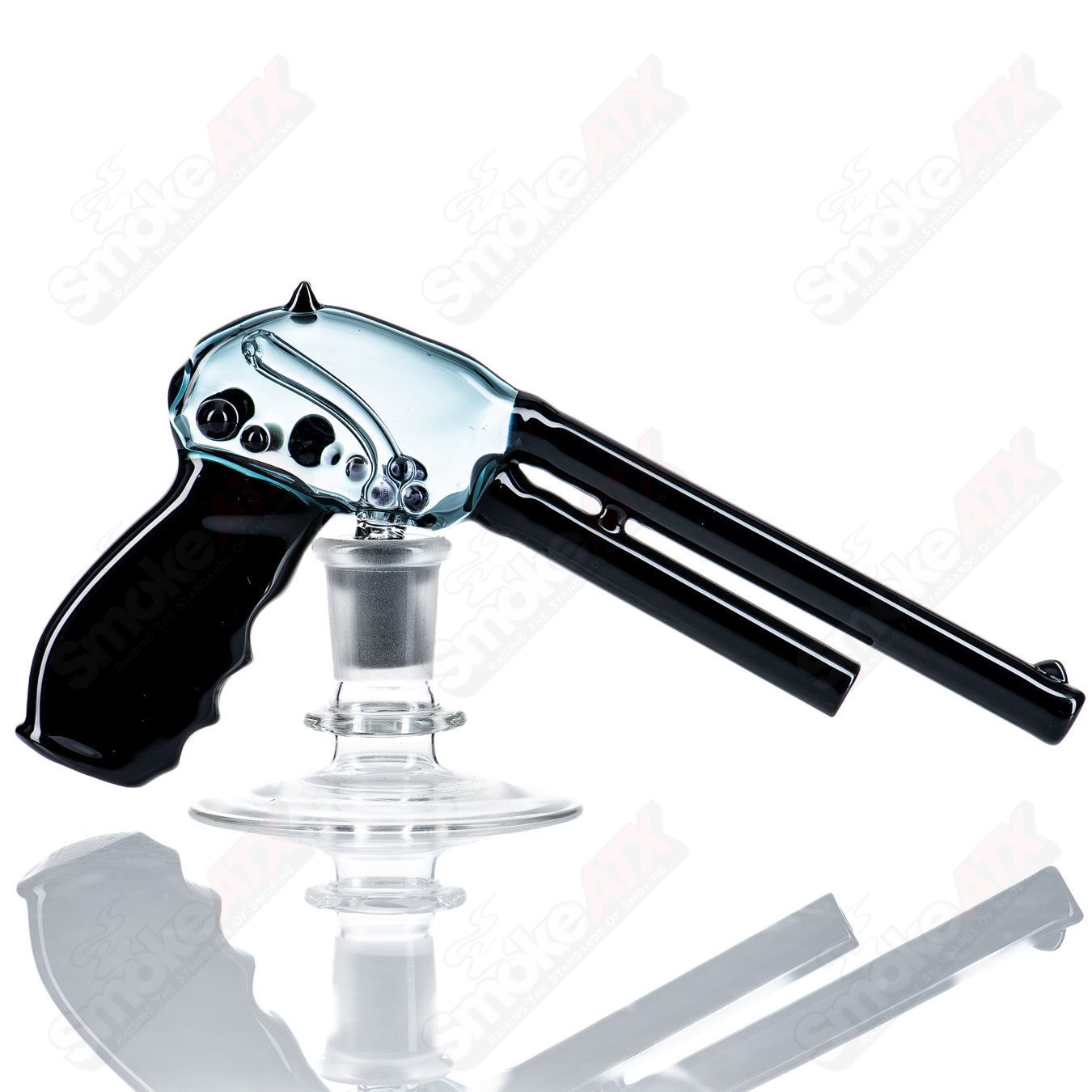 Heady glass pistol-shaped concentrate rig by JMass with intricate design and clear glass body for dabbing.