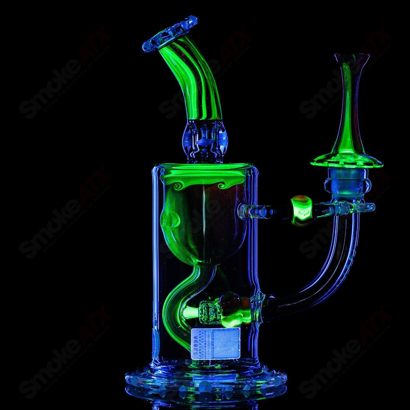 Mobius Recurve Accent Series glass concentrate rig with intricate design and clear glass body, showcasing artistic craftsmanship.