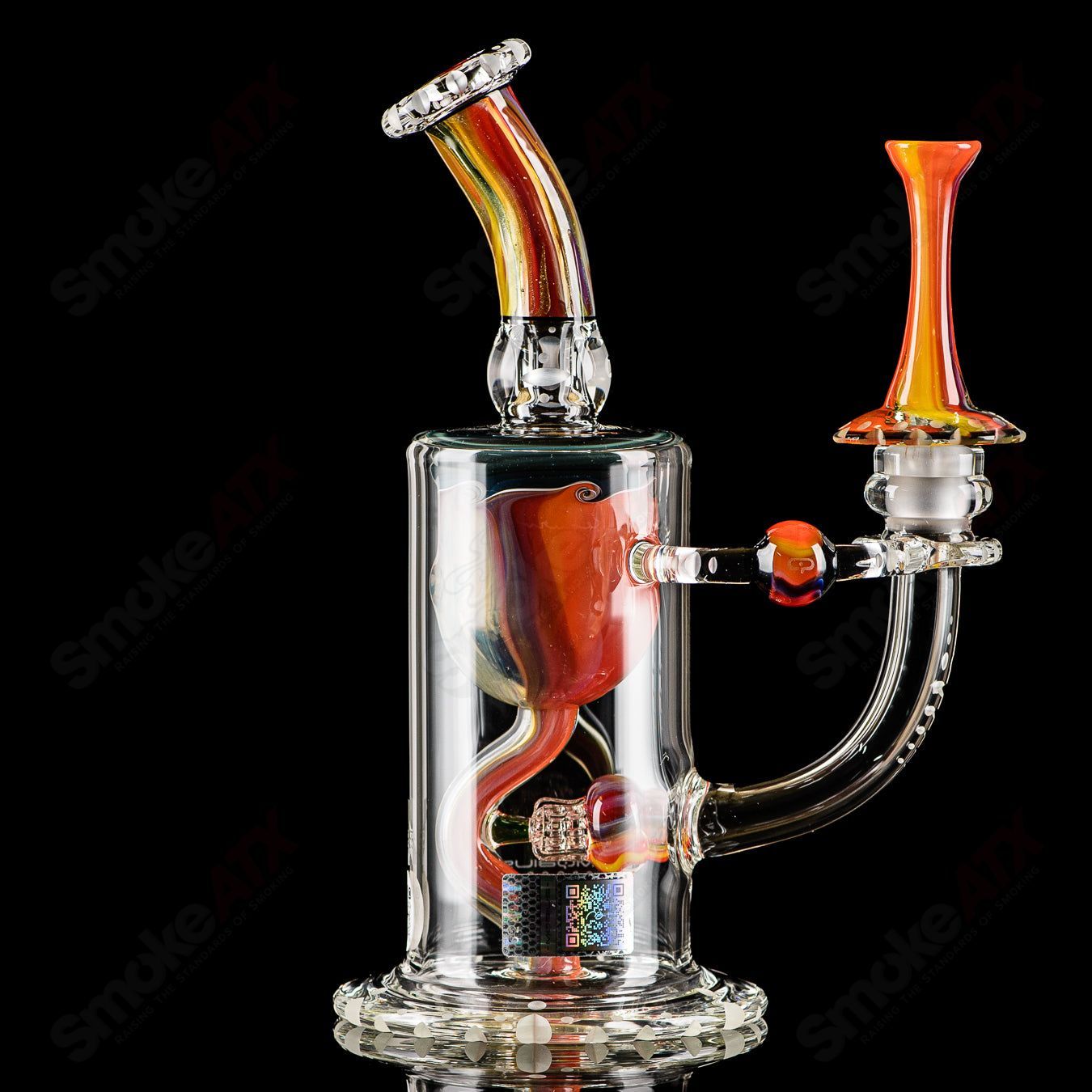 Mobius Recurve Accent Series glass concentrate rig with intricate design and clear glass construction, designed for concentrate use.