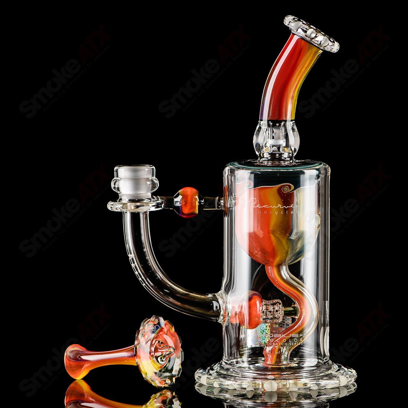 Mobius Recurve Accent Series glass concentrate rig with intricate design and clear glass construction.