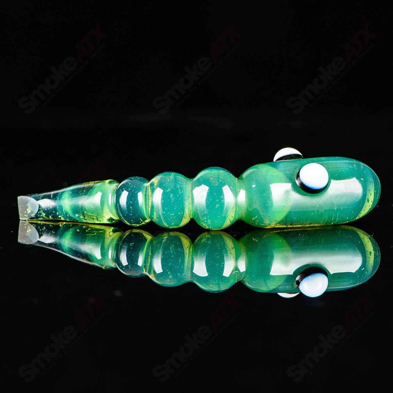 Red apple-shaped dab rig with worm-shaped dabber pouch, made of glass, by Pouch Glass, for concentrate dabbing.