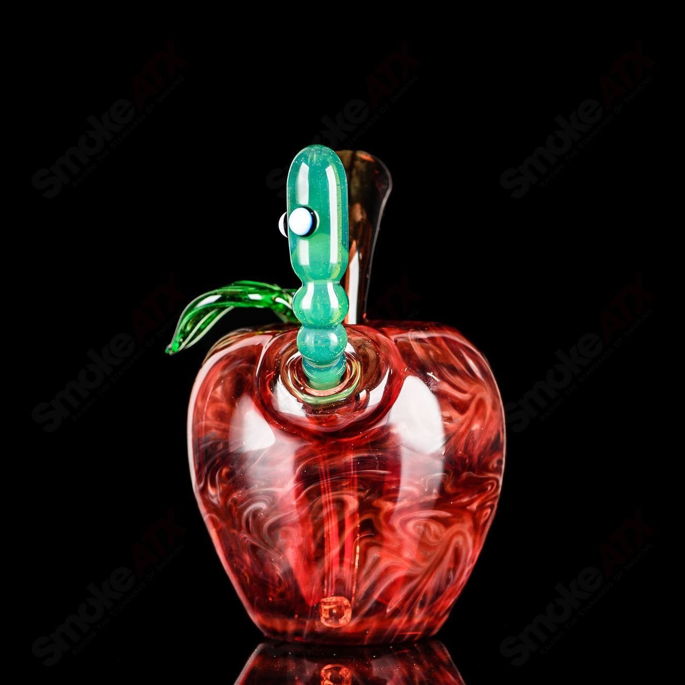 Red apple-shaped rig with worm dabber pouch, made of glass, from Pouch Glass, designed for concentrates and dabbing.
