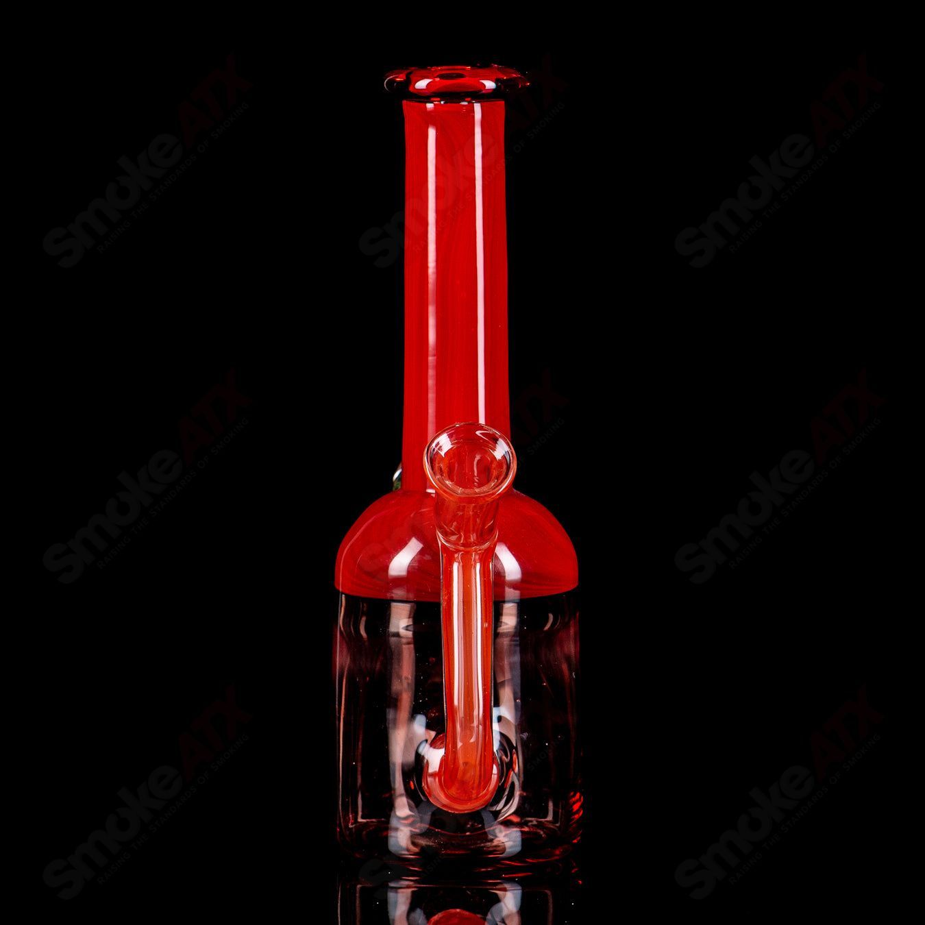 Red bell-shaped concentrate rig with fume marble by Kate B Glass, featuring vibrant red glass and swirling marble detail.
