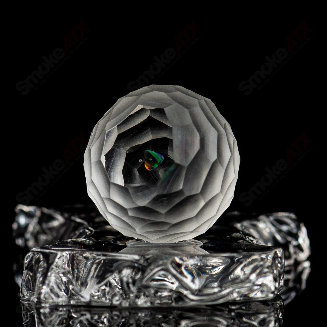 Faceted marble by Fatal Facets, a heady glass marble with intricate faceted design and smooth marble surface.
