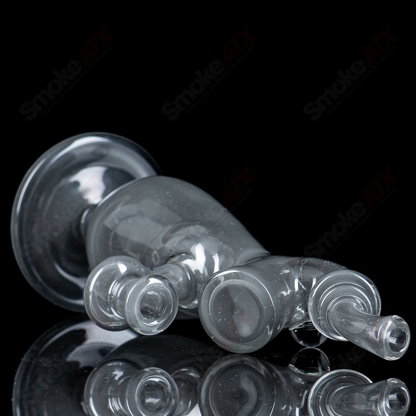 Sherlock-style glass concentrate rig with matching cap bottle by JMass, featuring intricate glass design and secure cap closure.