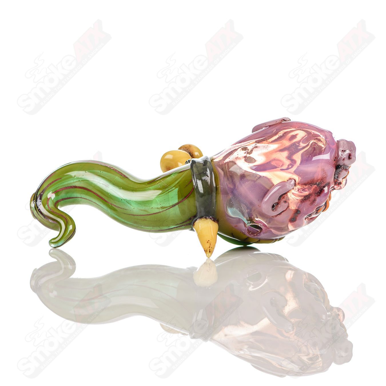 Hand pipe by Ghost Glass featuring a shrunken head design in clear glass with detailed facial features.