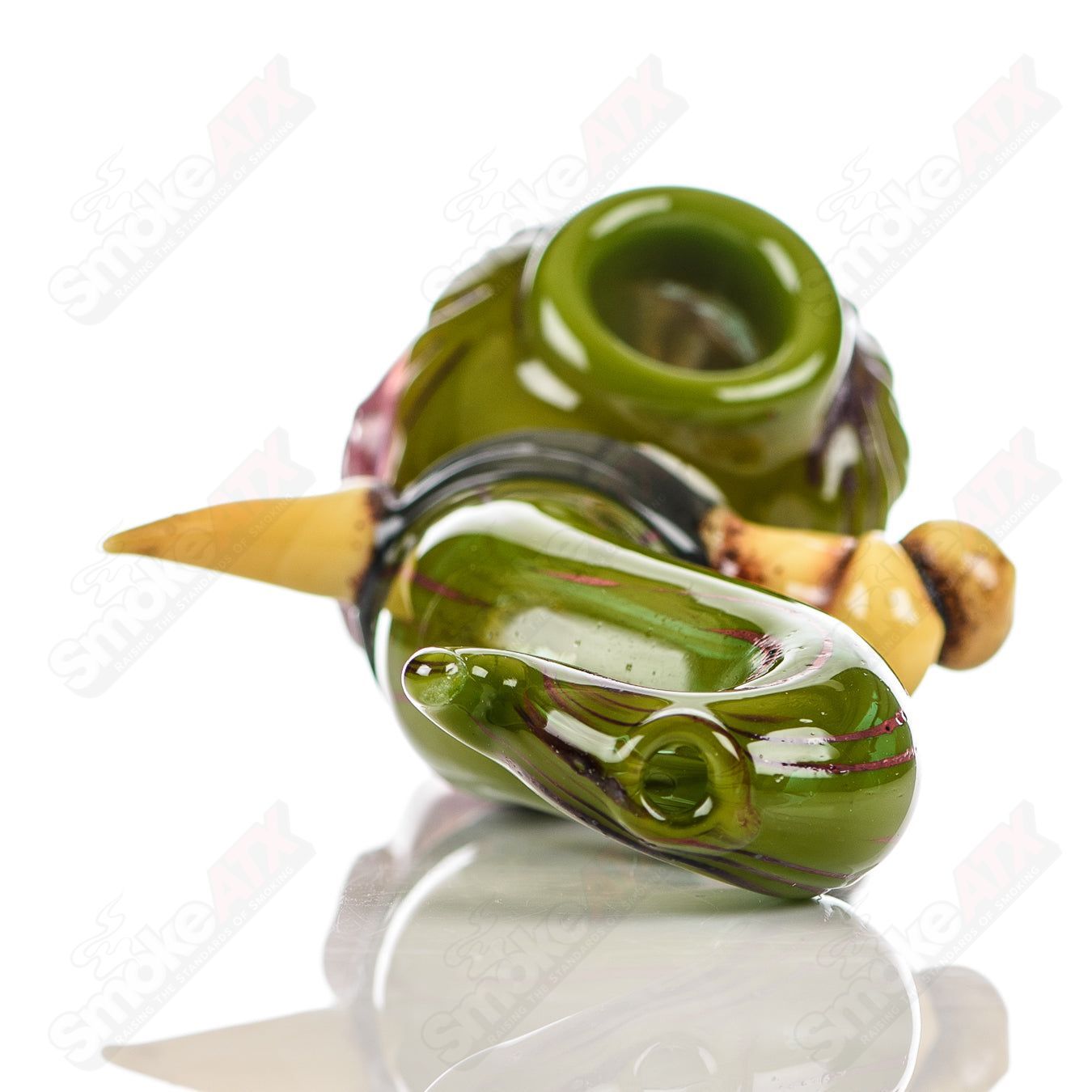 Handheld Ghost Glass shrunken head spoon pipe with detailed ghostly design, crafted for smooth smoking experiences.