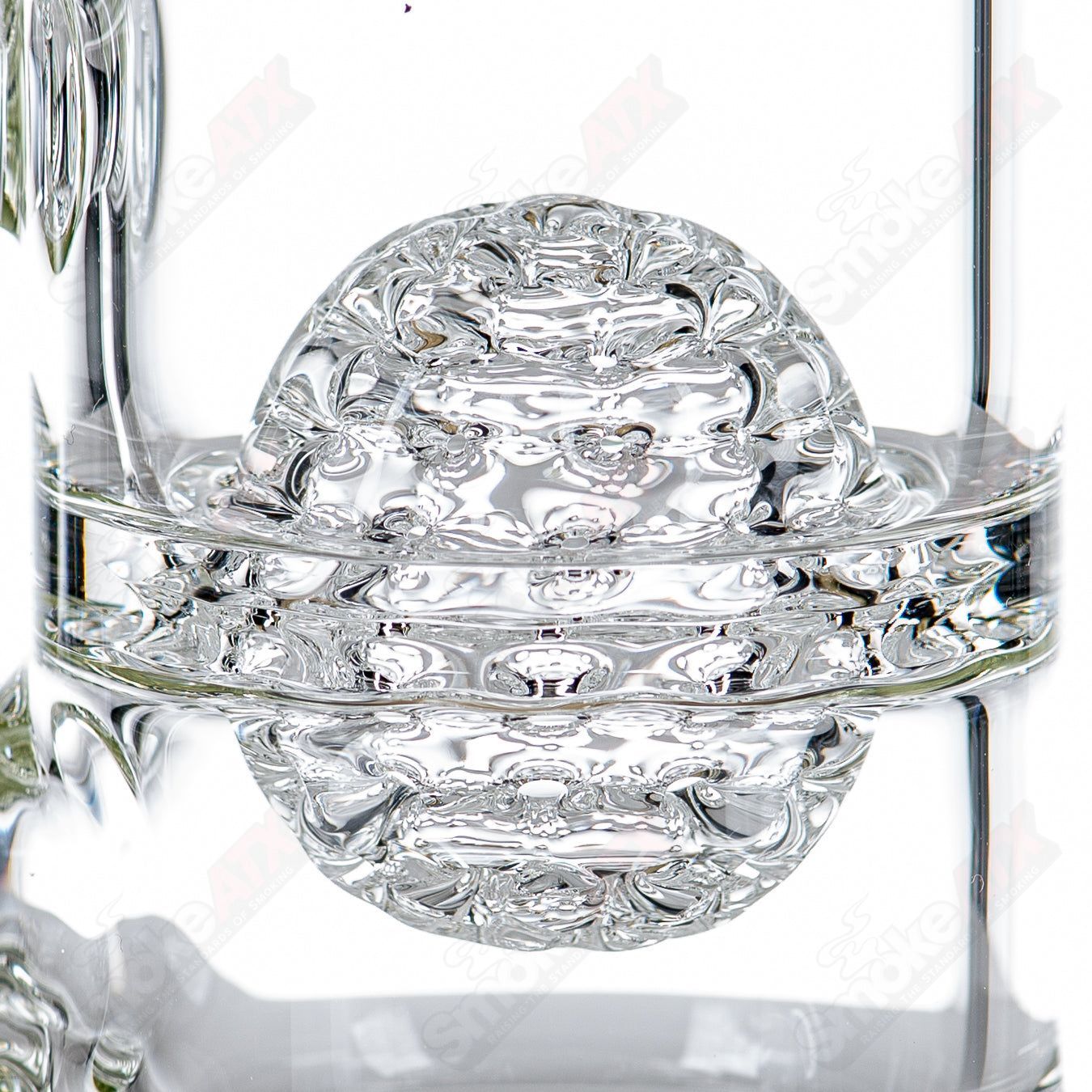 Clear glass waterpipe with intricate lace-sphere design by SoL Glassworks, showcasing detailed craftsmanship.