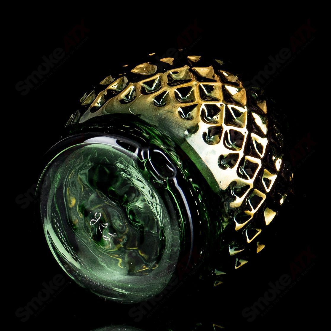 Emerald green glass Puffco top with gold diamond tech design by James Lang, featuring a spherical shape and intricate detailing.