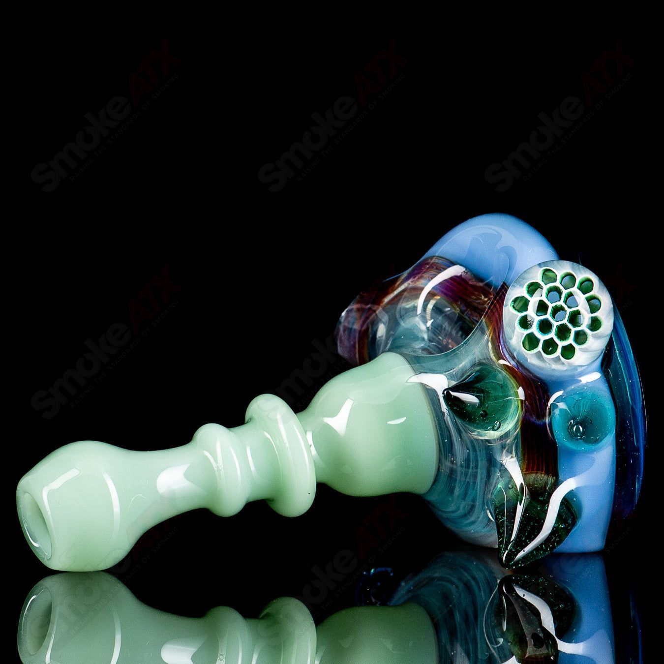 JMass Heady Glass spiked spoon hand pipe with honeycomb design and textured spikes, showcasing intricate glass craftsmanship.
