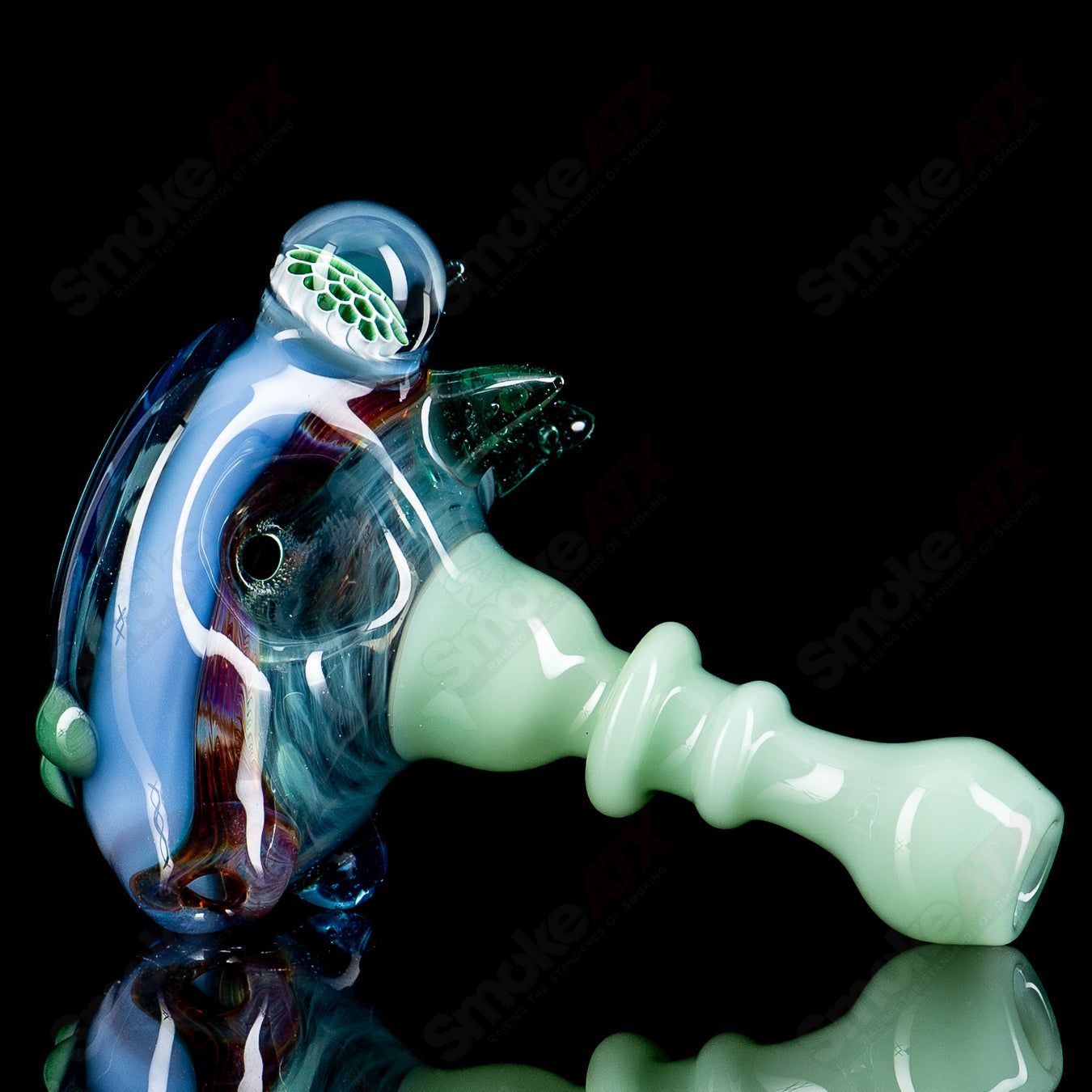 JMass Heady Glass spiked spoon pipe with honeycomb design, featuring a unique textured surface and intricate glasswork.