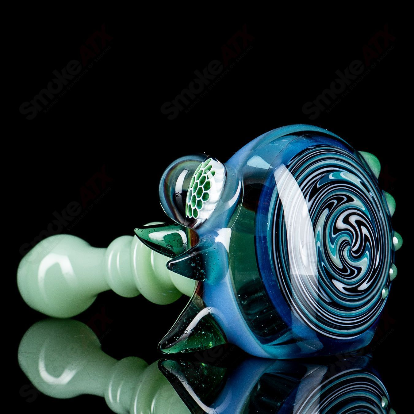 JMass Heady Glass spiked spoon hand pipe with honeycomb details, featuring a unique spiked design and intricate honeycomb pattern.