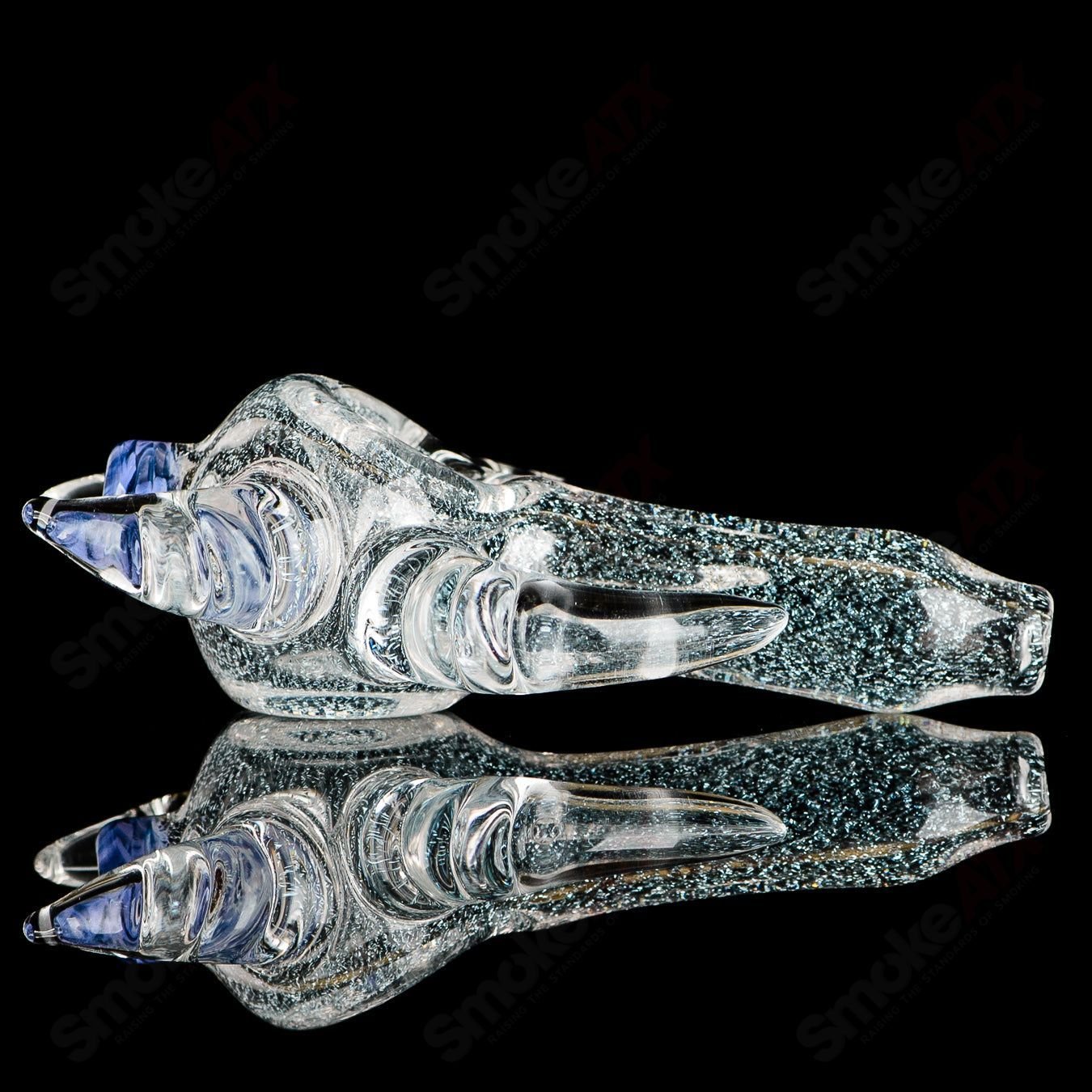 Transparent Dichro 4-Horned Spoon hand pipe with purple accent and signature from JMK Glass, showcasing its unique glass design.