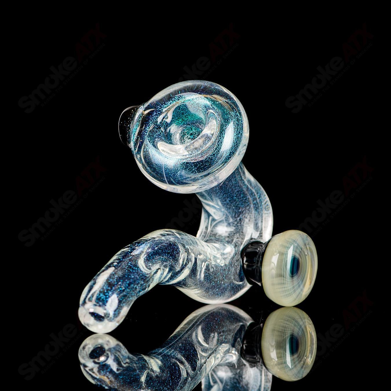 Transparent Dichro Sherlock glass by JMK Glass featuring a signed Sherlock design with colorful, reflective dichroic glass details.