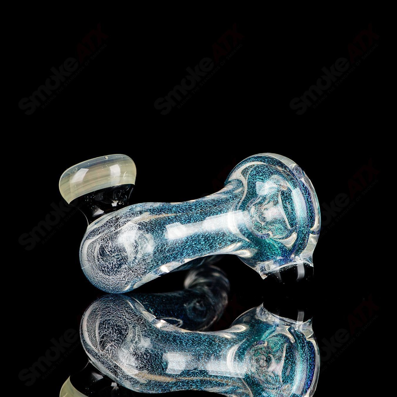 Transparent Dichro Sherlock glass by JMK Glass, signed, showcasing vibrant color shifts and intricate design details.