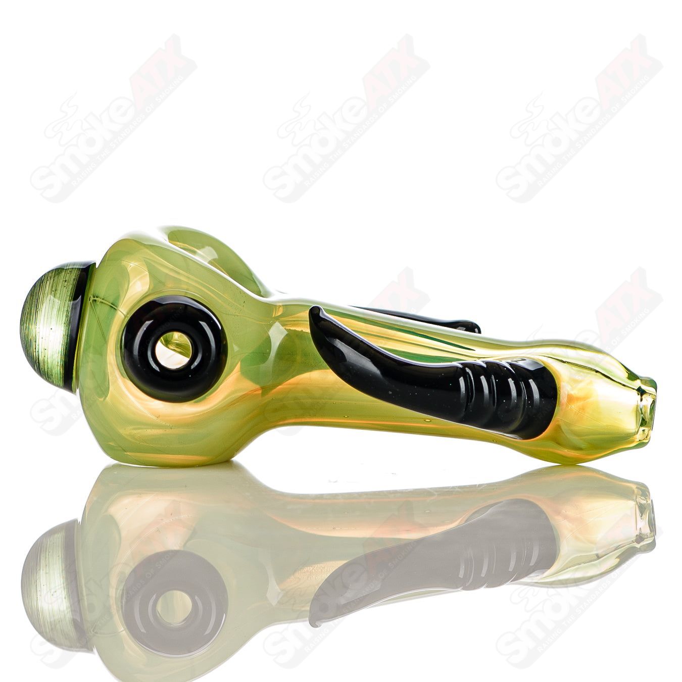 Transparent green glass spoon pipe with black horn accents, signed by JMK Glass, designed for hand pipe use.